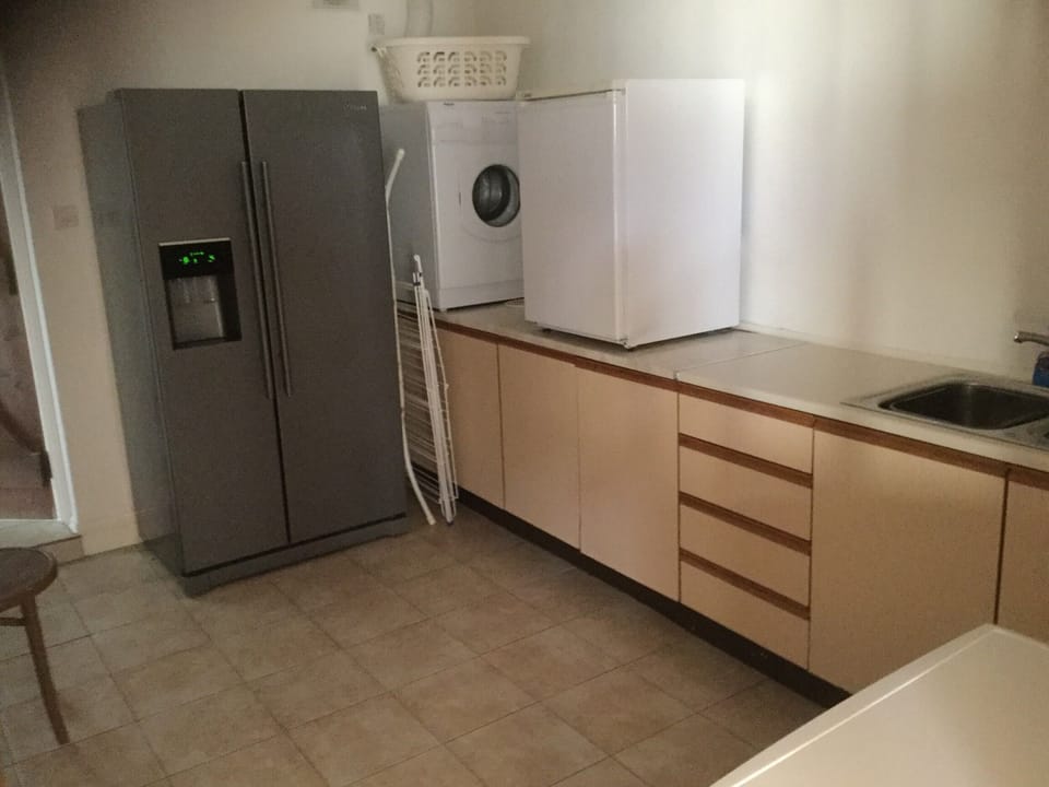 utility room with fridge freezer , drinks fridge , washer and dryer