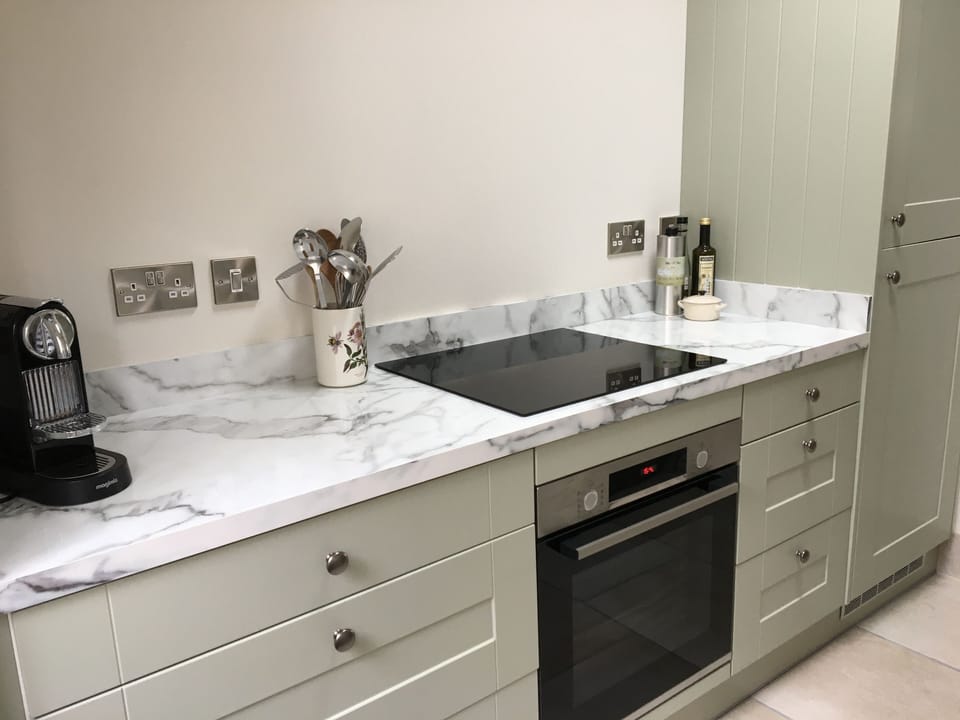 Newly fitted galley kitchen leading from dining room
