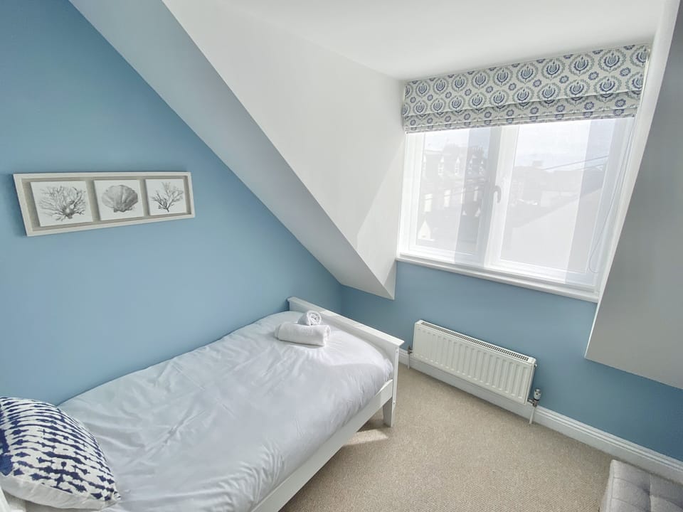 Twin bedroom with views towards the sea