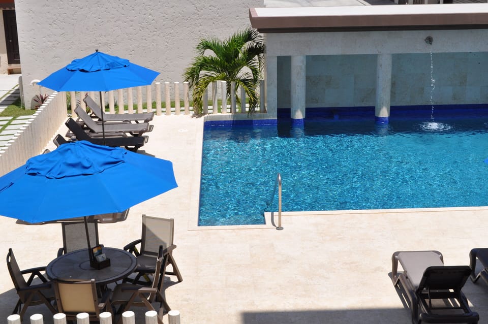 view of pool from balcony outside unit