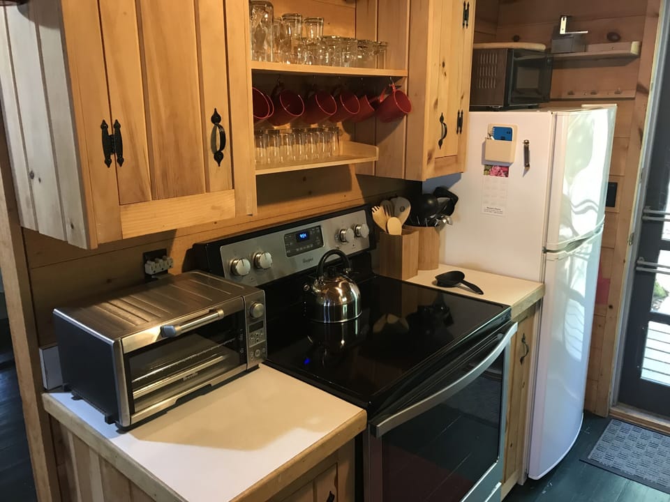 aisle kitchen with full size range, toaster oven and refrigerator