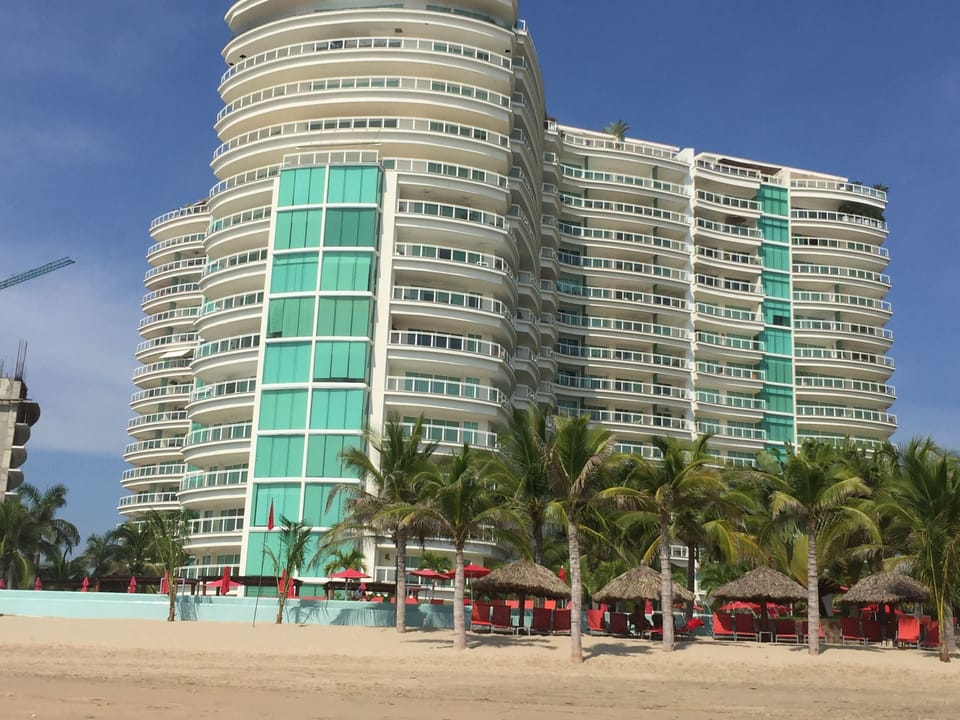 From beach, looking at building, right side, 8th floor where the shade is.