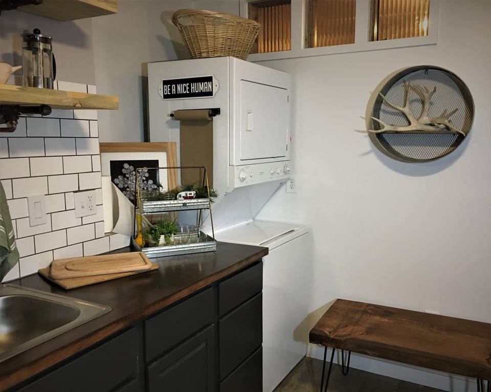 The kitchen area is fully stocked and has a clothes washer and dryer.