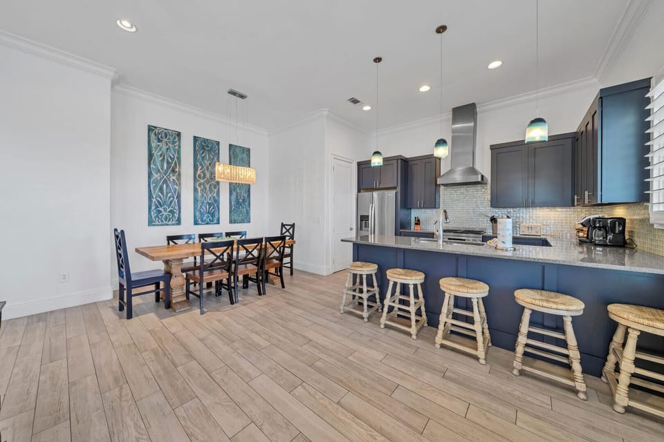 The dining area offers seating for 8, +10 at the breakfast bar and balcony!
