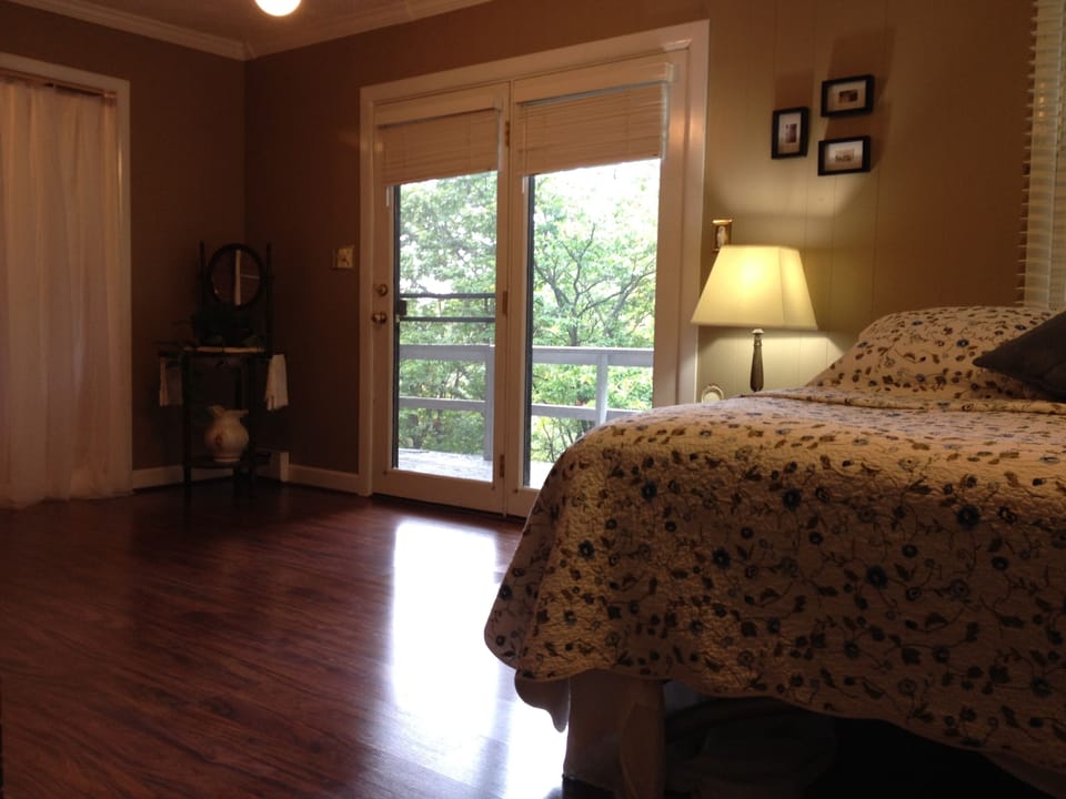 Master bedroom access to upper deck. Beautiful nature views.