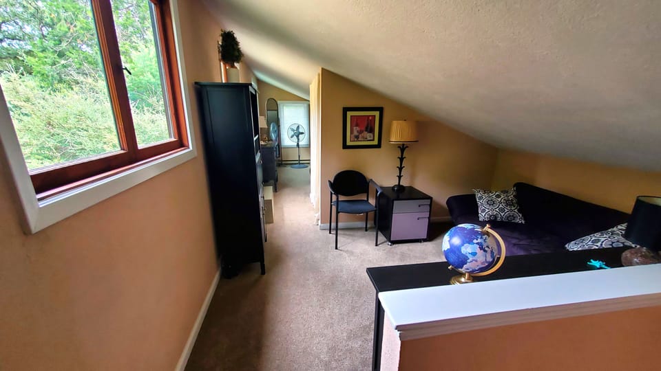 A view of the upstairs office, with the second bedroom down the hall.