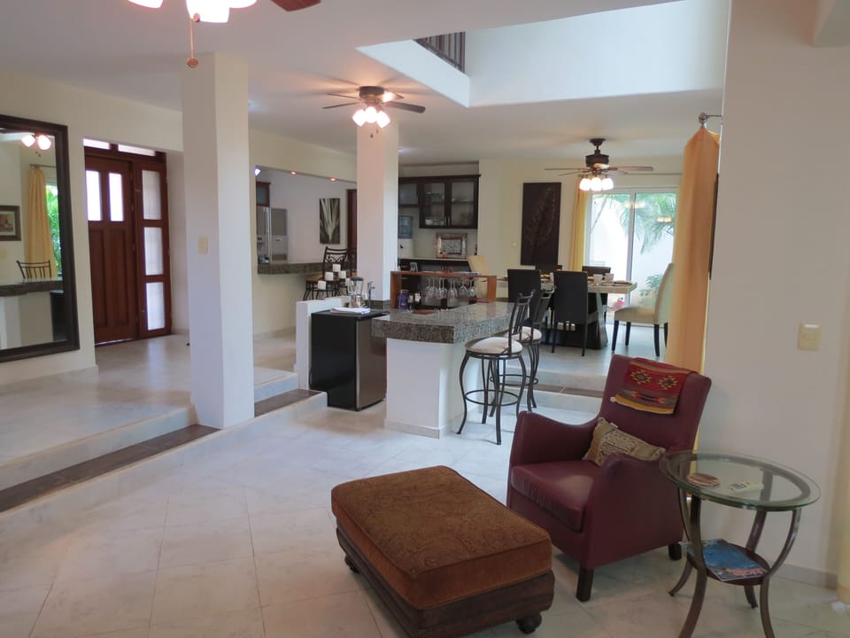 View from LR:  Bar area, Dining room, Front door and Kitchen counter top.
