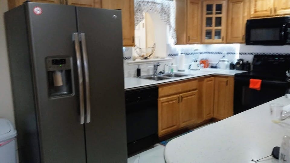 Kitchen with slate refrigerator with ice maker and filtered water.