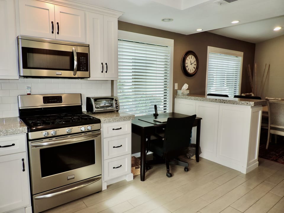 A desk and chair in the kitchen comes in handy.