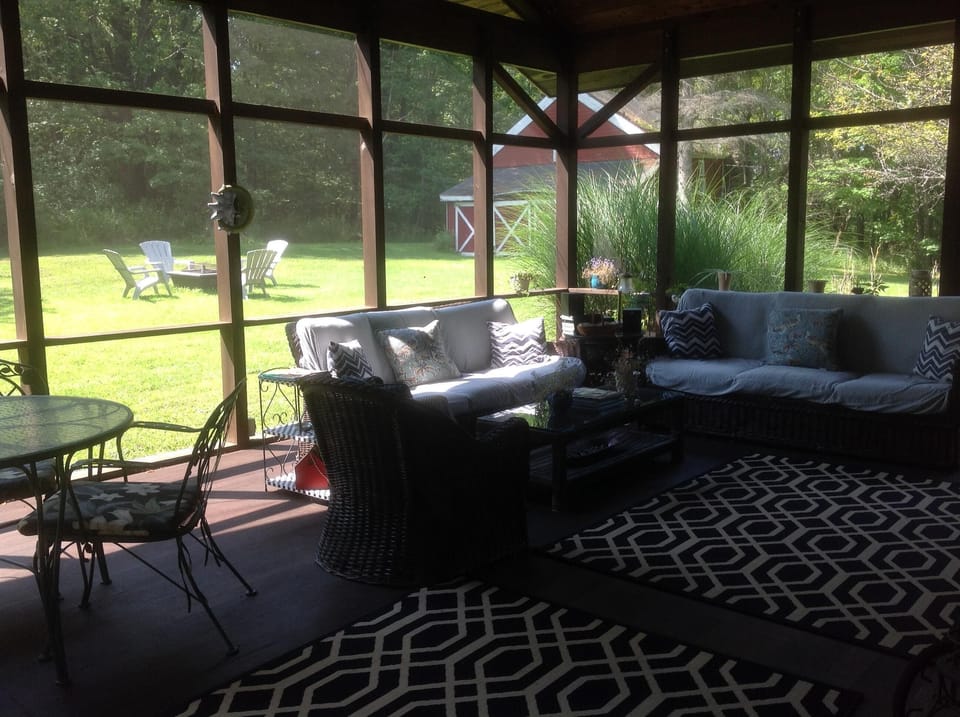 Screened in porch just off the kitchen and close to the fire pit