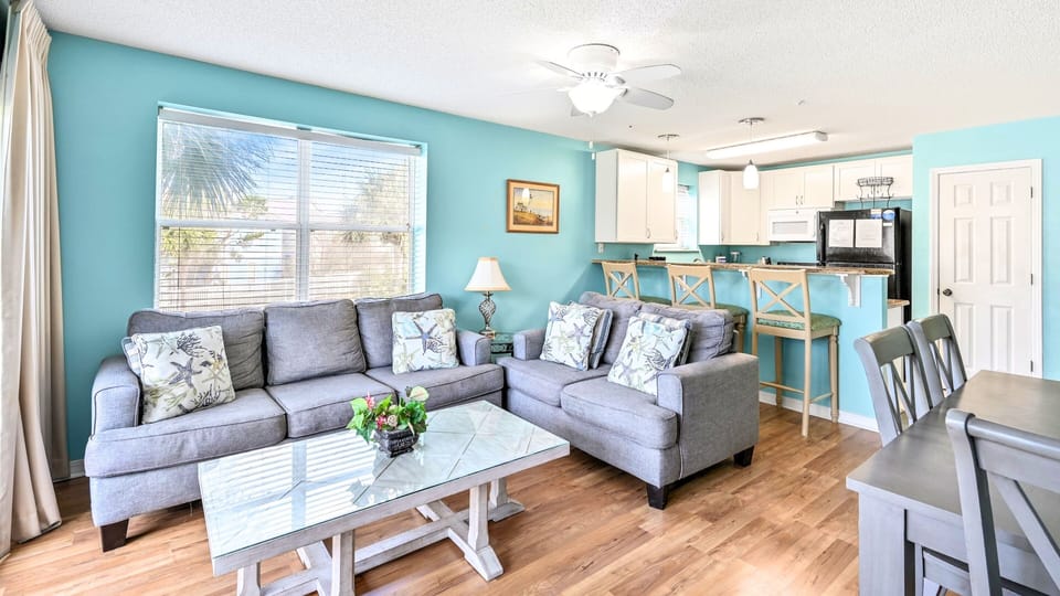 An open layout with a breakfast bar opening to the living room.