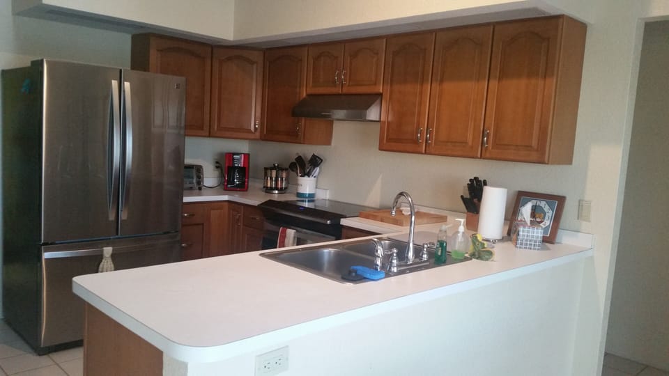 the kitchen, fully stocked with cook ware, appliances and dining/serving items.