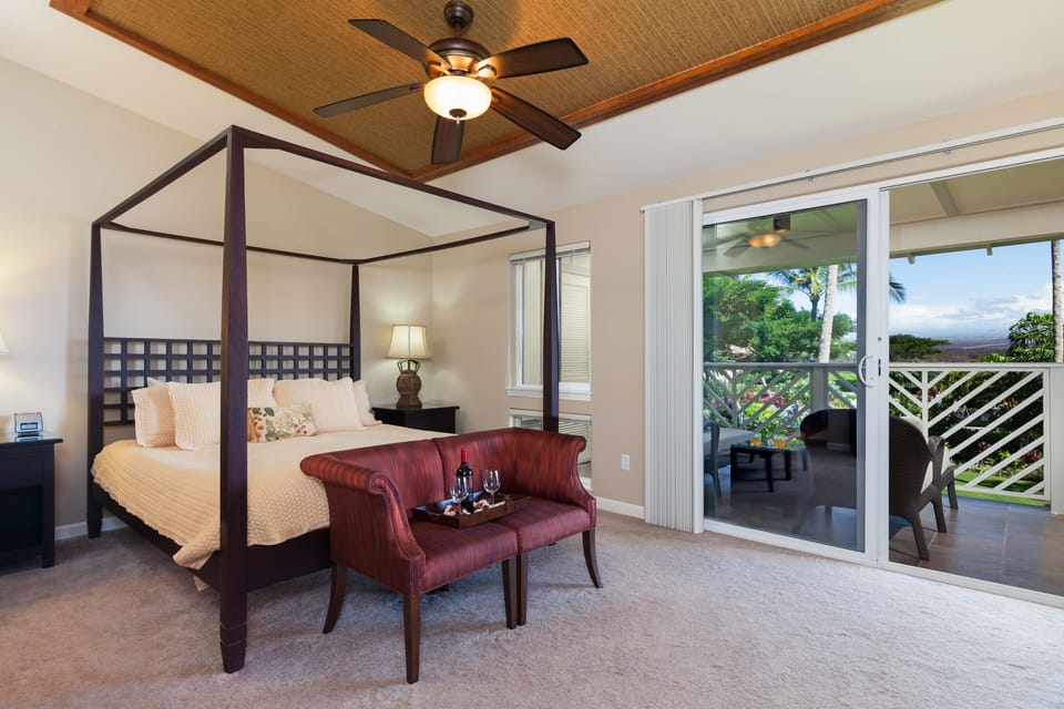 Spacious master bedroom with balcony overlooking the pool