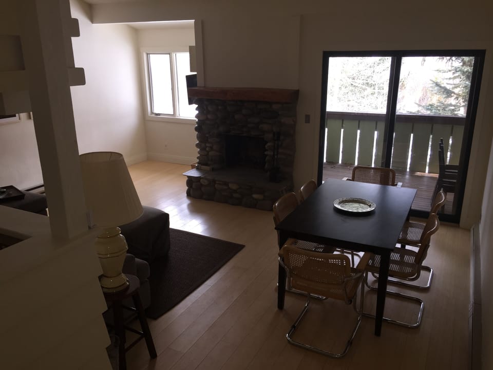 Living room from stairs out to porch.  Charcoal grill on the porch.