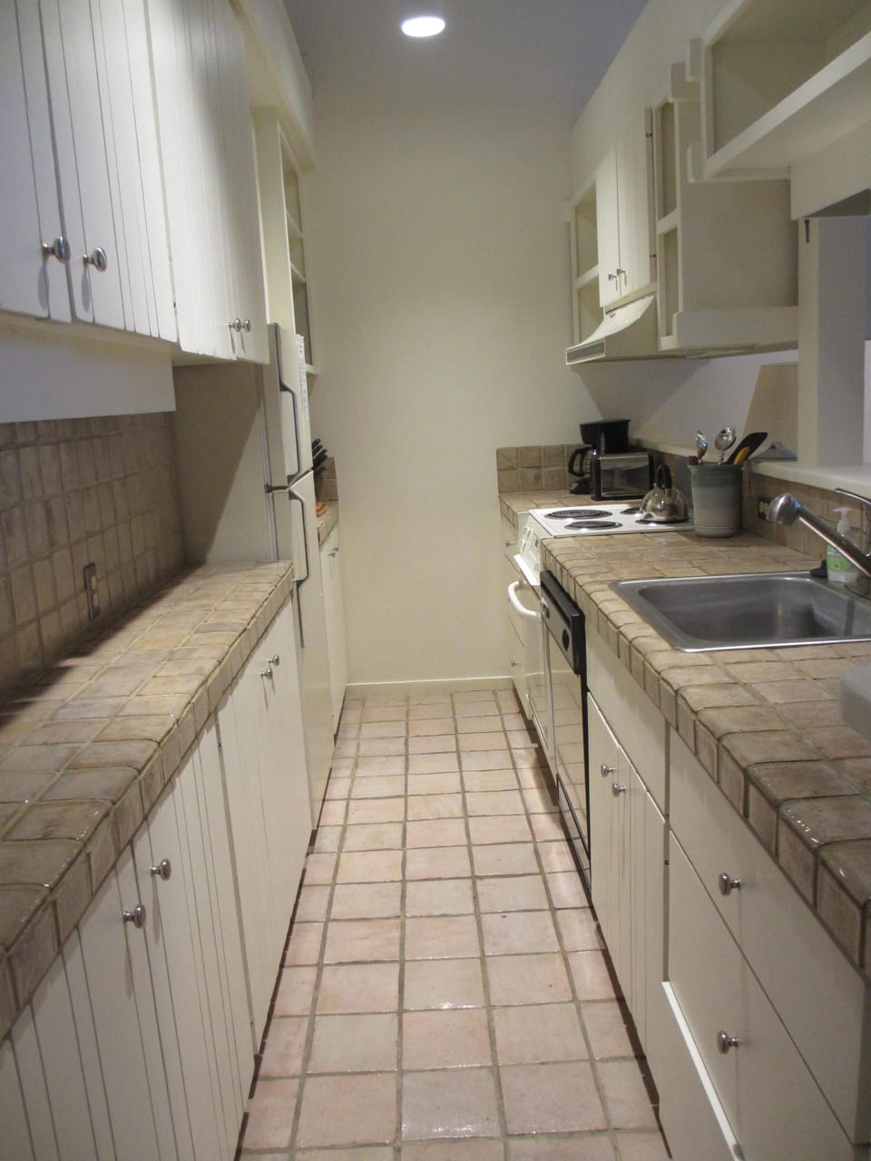 Kitchen fully stocked. Coffee maker, tea pot, toaster, dishes, pots & pans, 