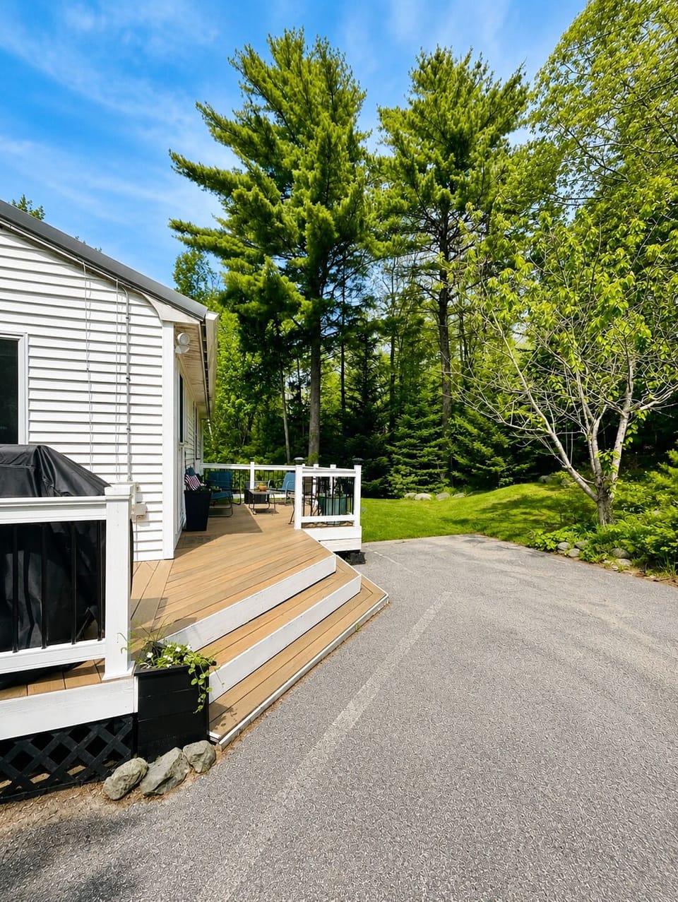 Welcoming entrance with a private deck, grill, and outdoor seating.