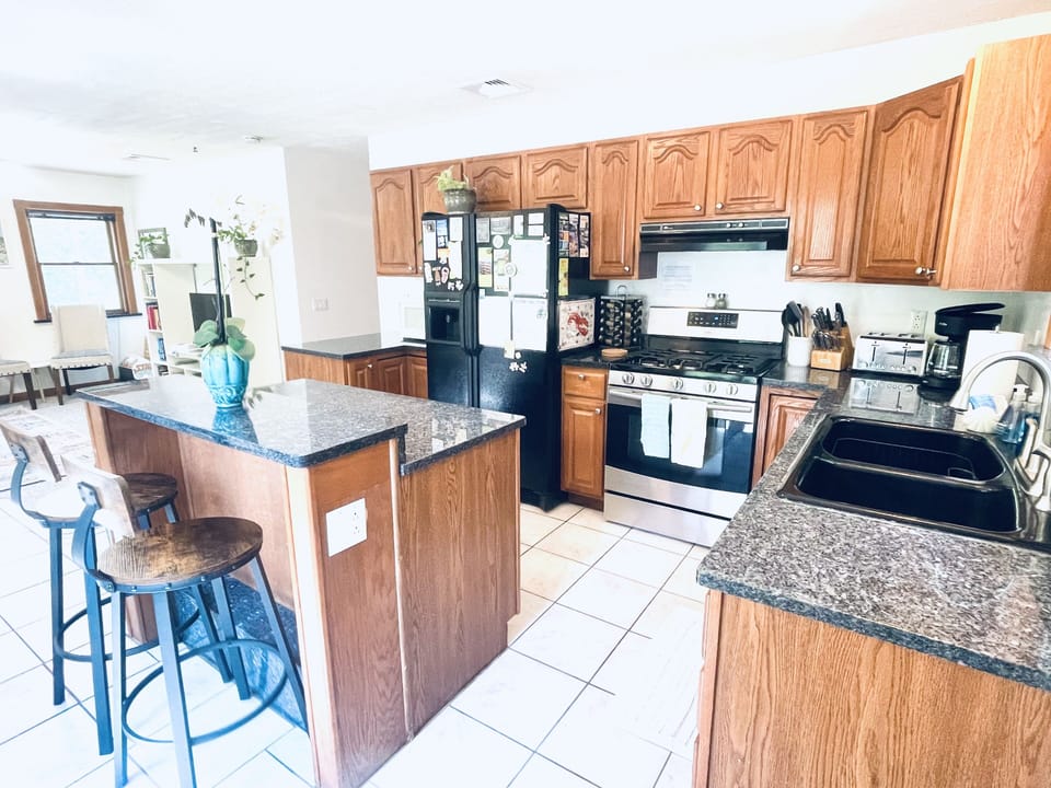Full open concept kitchen & breakfast bar. Windows overlook the deck & backyard.
