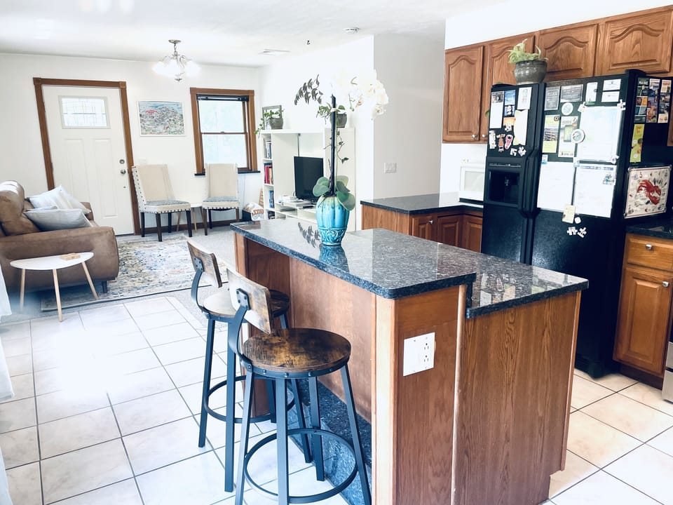 Open concept kitchen/living area.  Granite countertops, tile floors, 2-seat bar