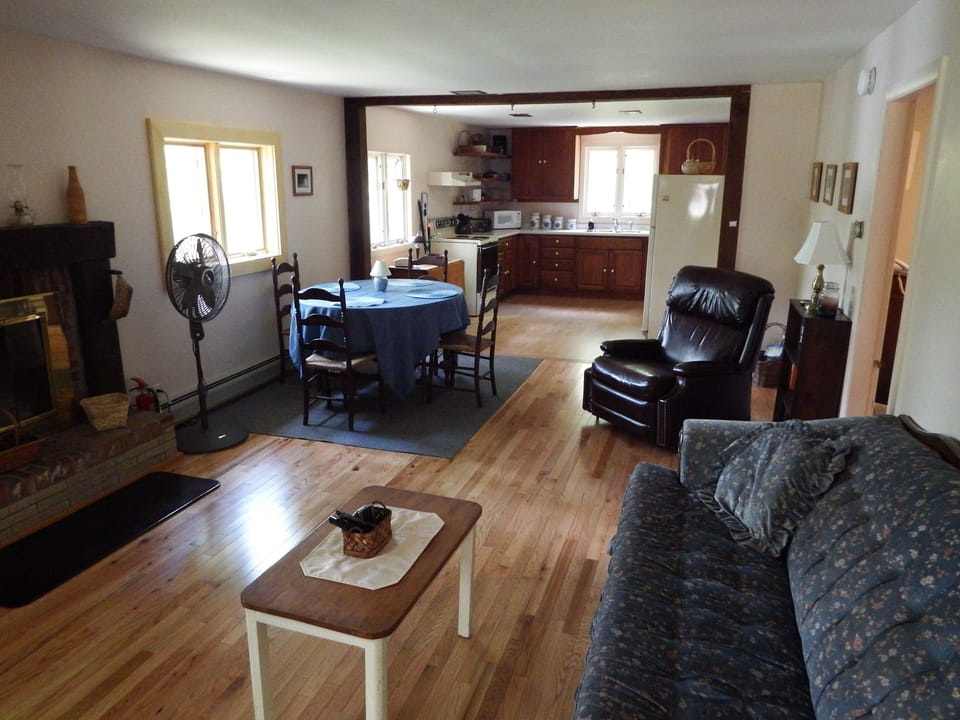 The Living Room, Dining Room and Kitchen with all windows with a pond view .