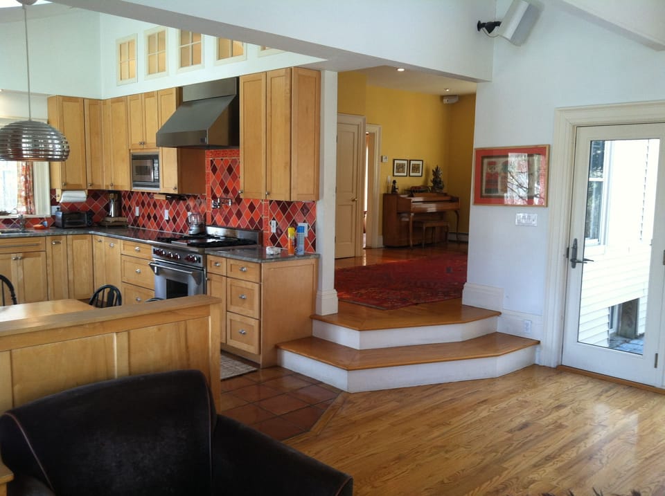 View from Great Room to Kitchen and Gallery with Piano