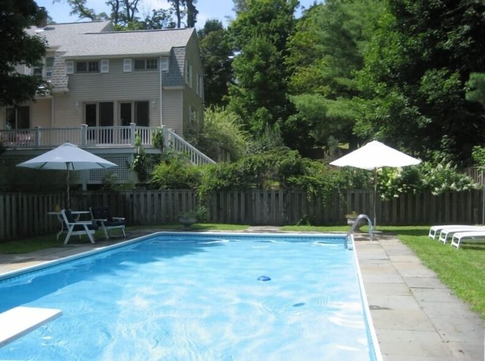 Enclosed pool area, view to deck in back of house.