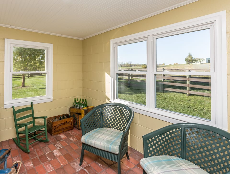 Cozy back porch with views of the paddock, hayfields and pastures.