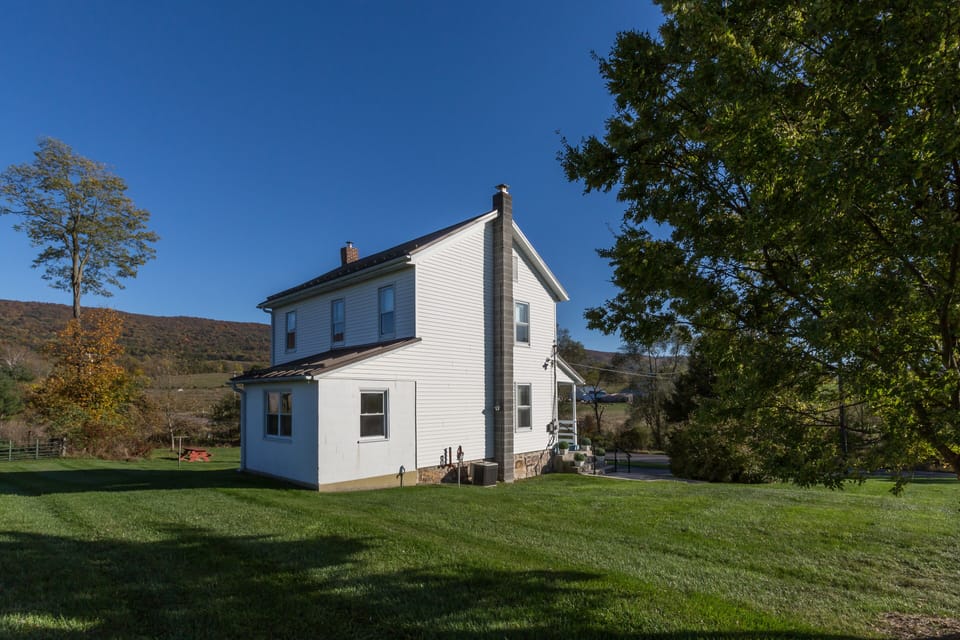 The side yard and back of The Tenant House with Tuscarora Mountain behind.