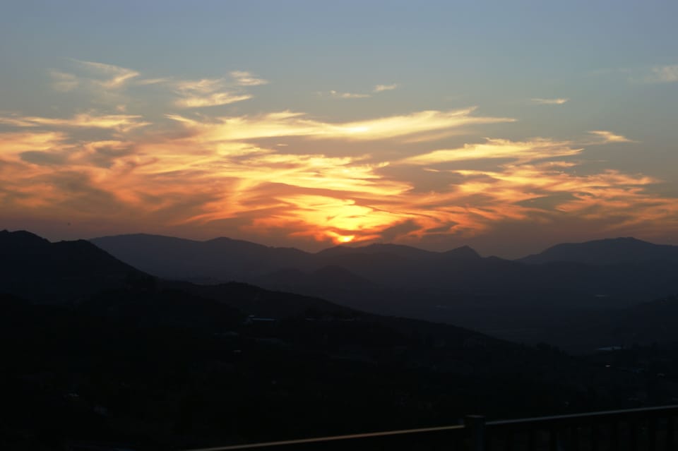 View from the back patio, sunroom, deck, game room and 3 bedrooms at sunset.