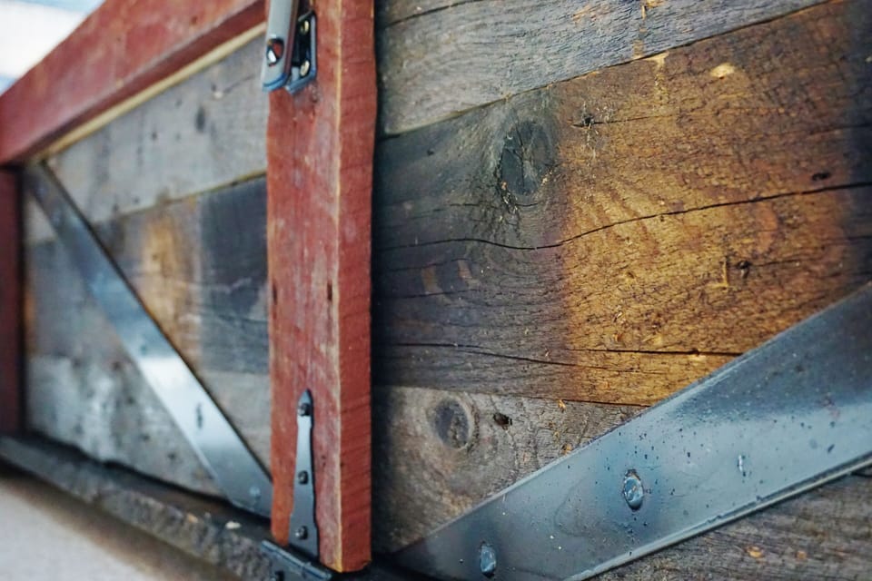 Closeup of the rustic window daybed built with hundred year old barnwood