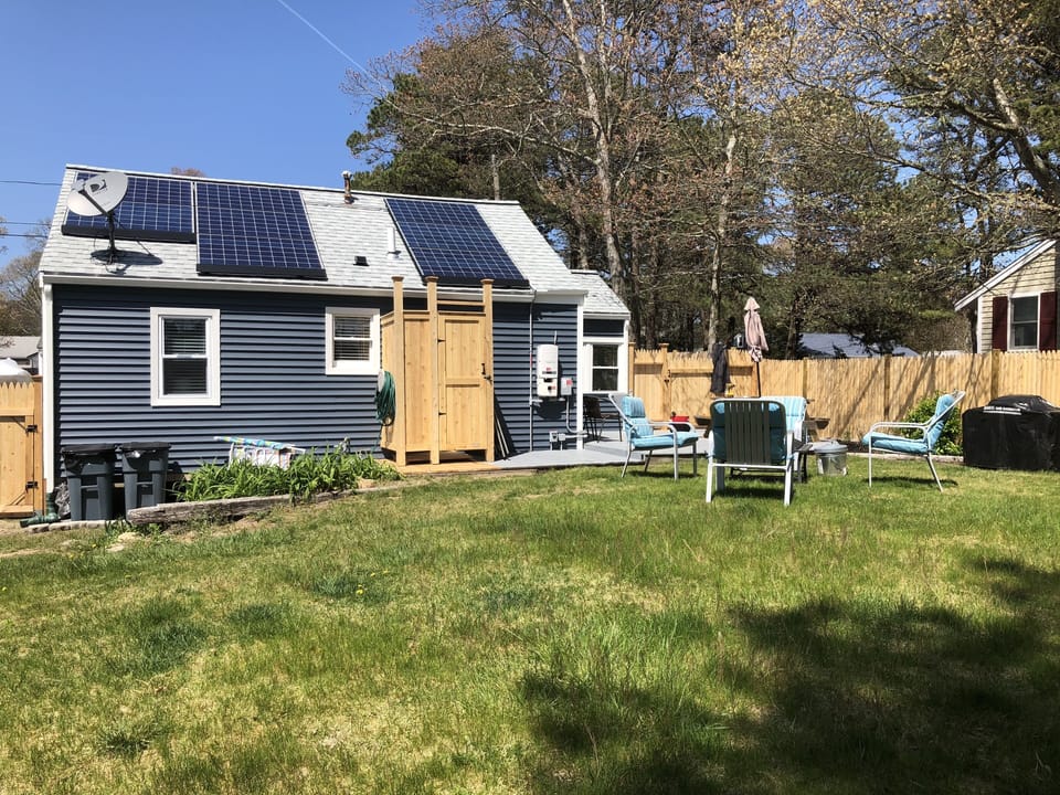 Backyard with new outdoor shower enclosure 