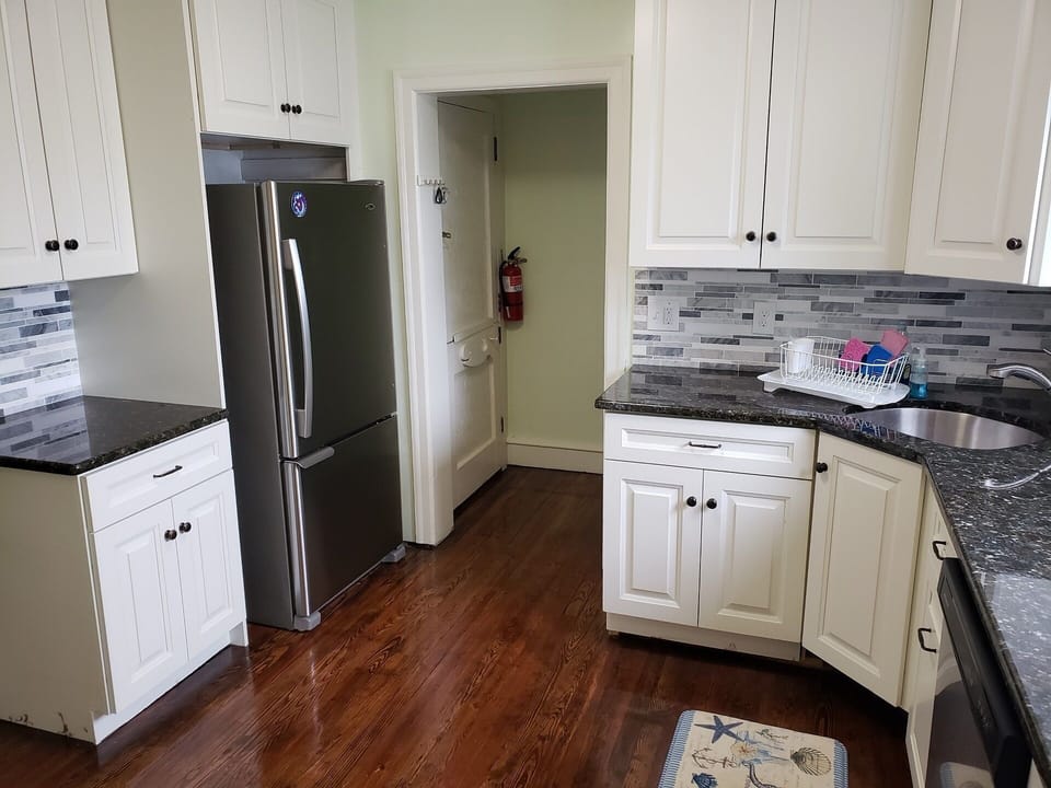 Updated kitchen includes fully restored original hardwood floors