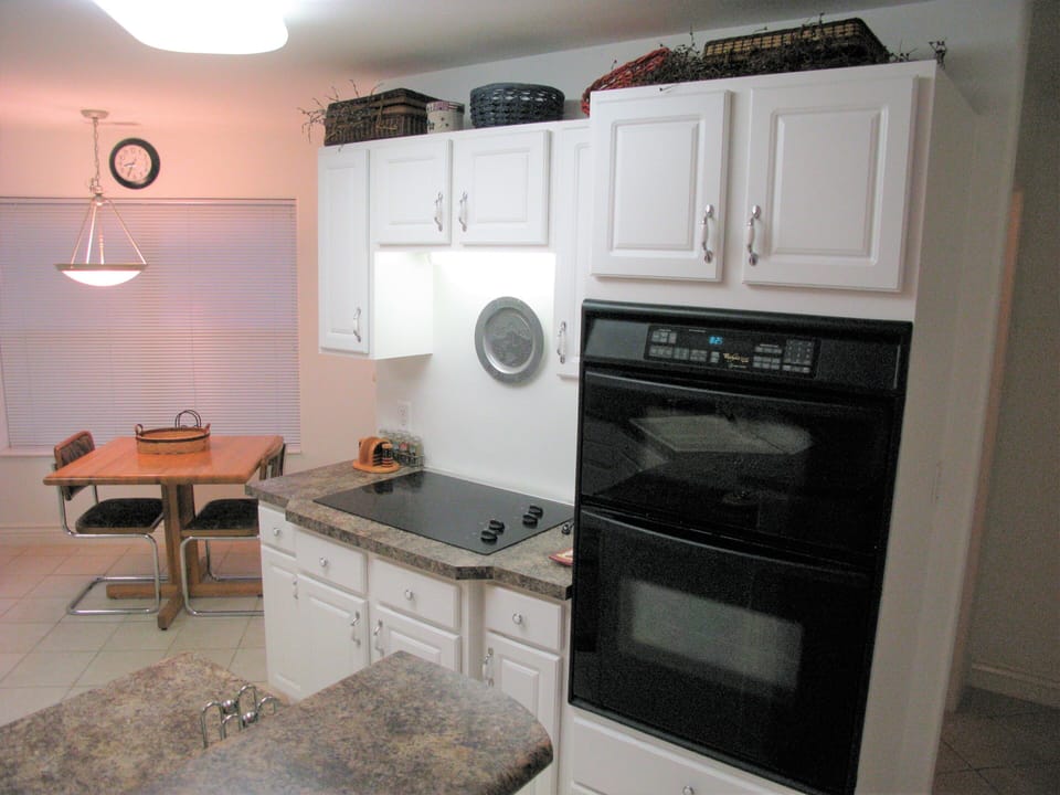 Kitchen's cooking areas. Microwave, Oven, and Cooktop with exhaust system.