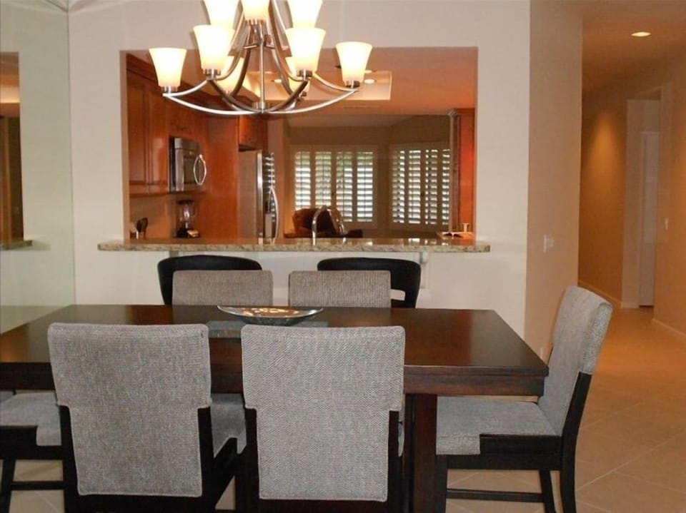 Dining Room with large dining table. Granite counter with bar stools