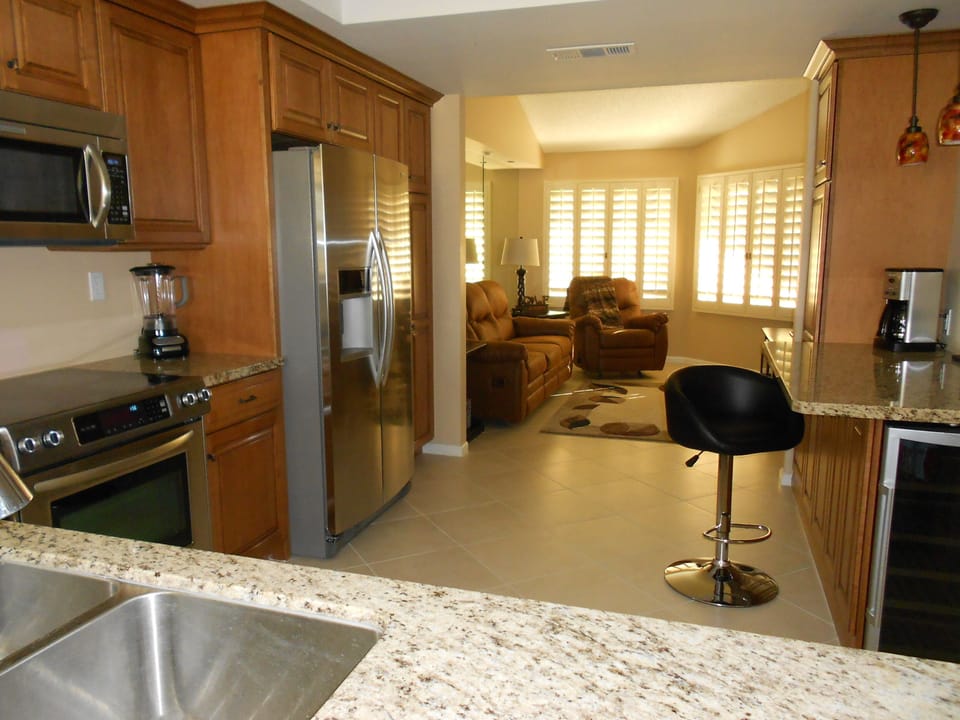 Looking through the bar into the kitchen and den