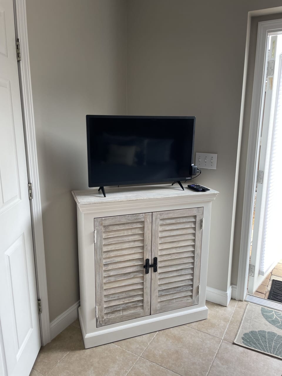 New TV and new TV stand in downstairs queen bedroom.