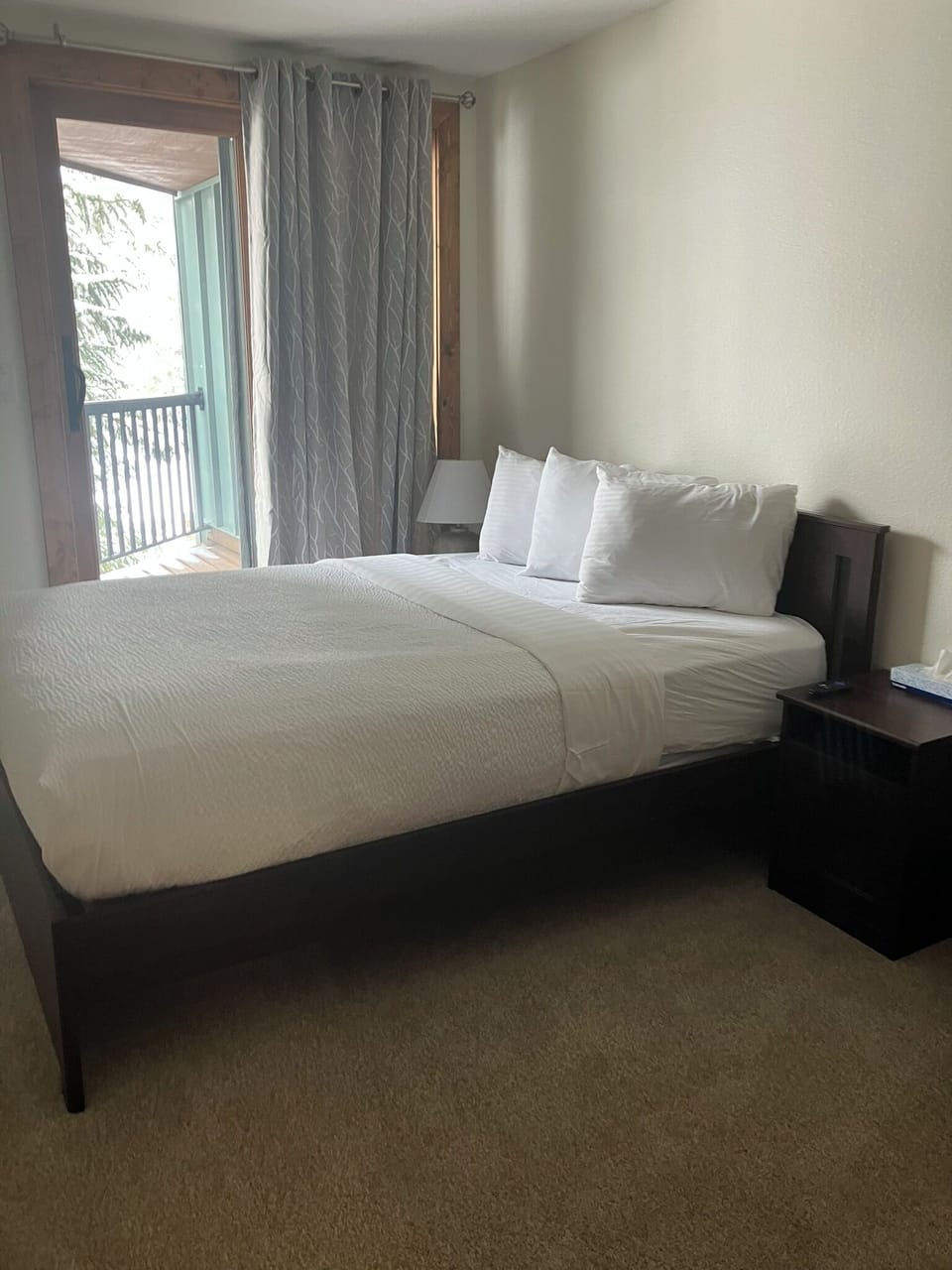 Bedroom 1.  Queen Bed. Balcony. TV.