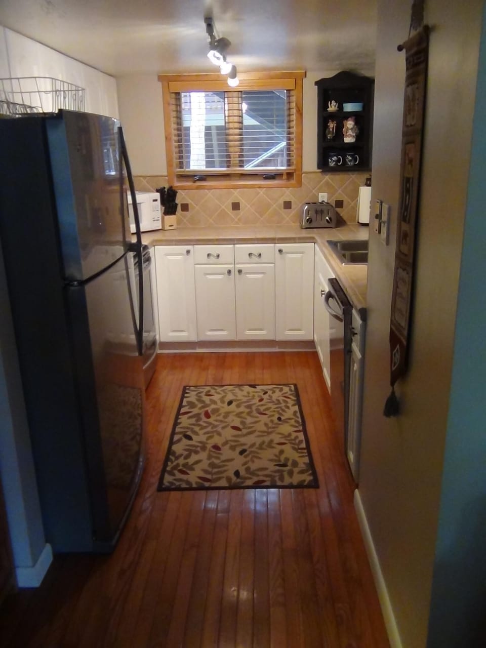 Kitchen has custom Italian porcelain tile and stainless steel appliances
