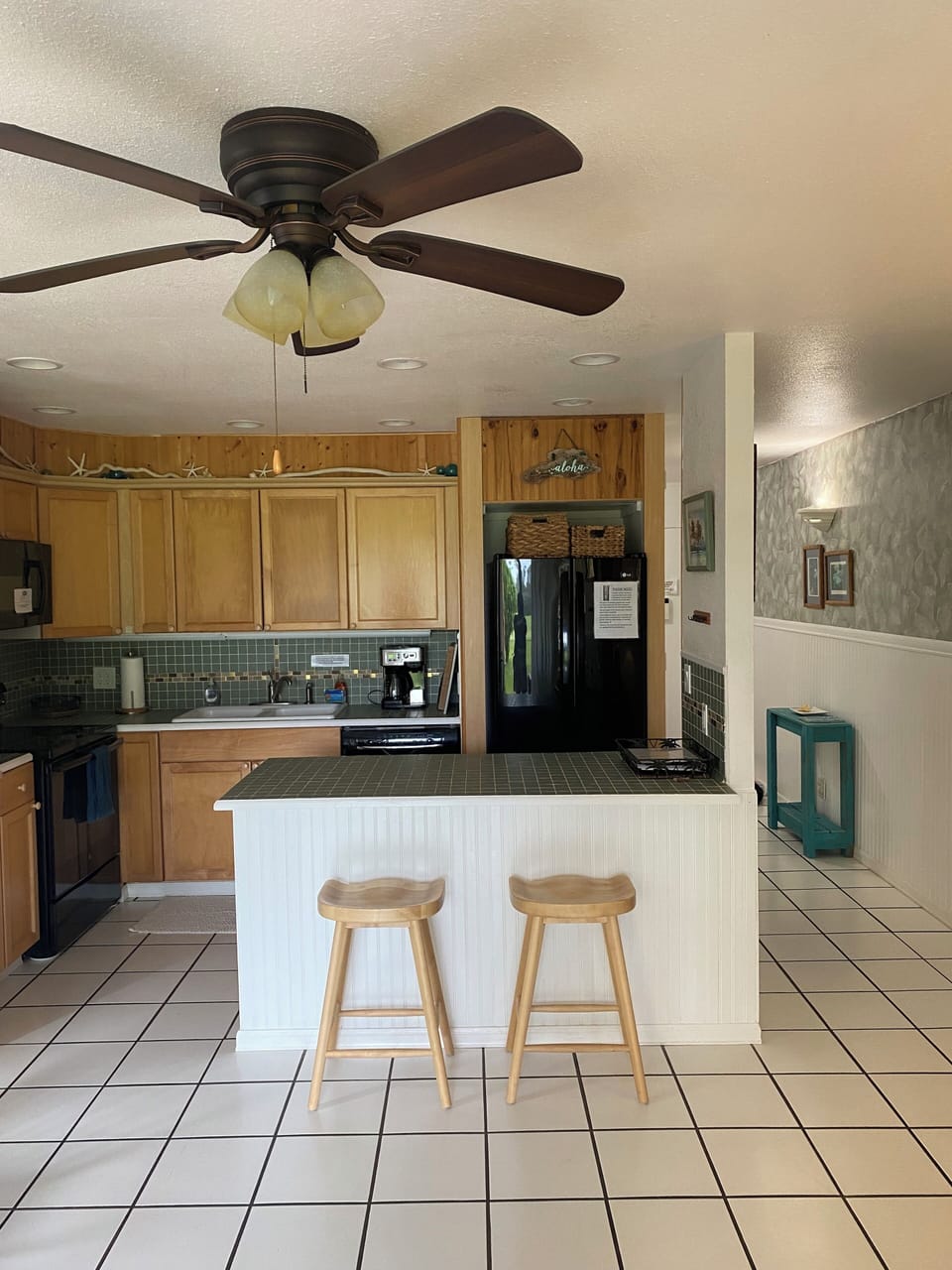 Bar/counter between living area and kitchen. Cooled by 2 ceiling fans. 