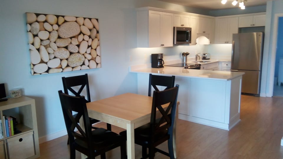 Dining table has two pull-out extensions. Photo art by Robin Rezende
