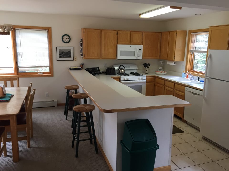 Fully stock kitchen with breakfast bar and adjoining dining room