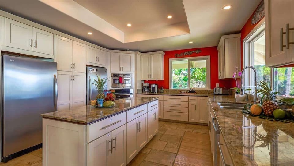 kitchen has large standing refrigerator and a standing freezer