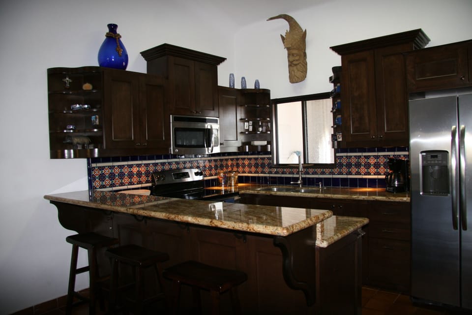 The kitchen features granite counter tops and stainless steel appliances.