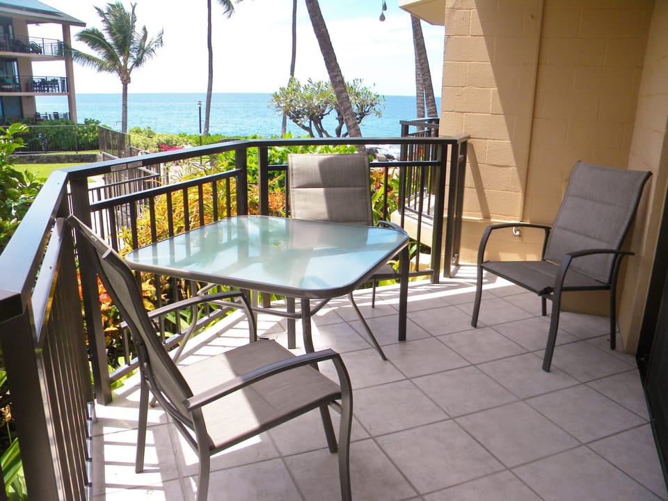 New table and chairs, with view of ocean
