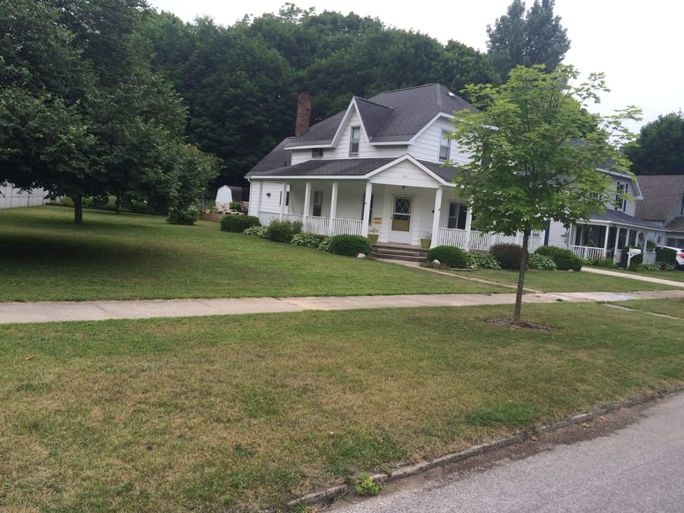 Large grassed yard and wrap around porch