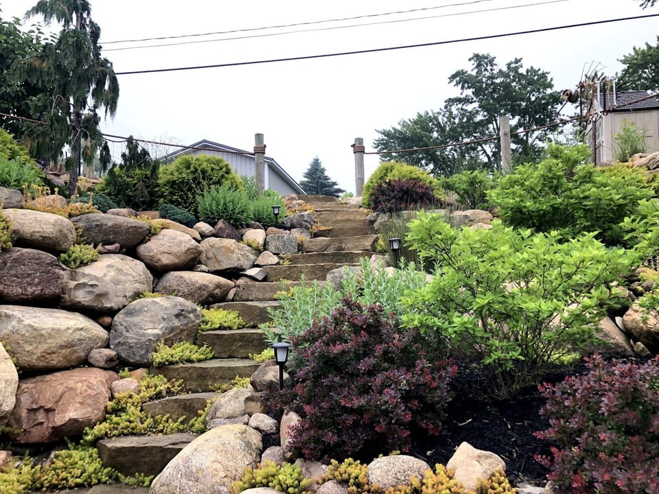There are 20 natural stone steps to navigate to get to the house-NO railing.