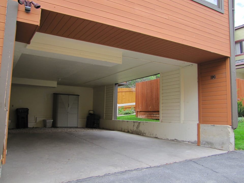 Covered 2 vehicle carport under unit.  Hot Tub is uphill to right.