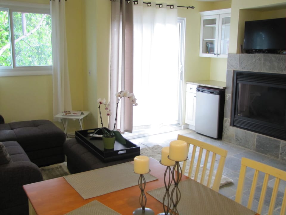 Dining area looking toward deck and fireplace.