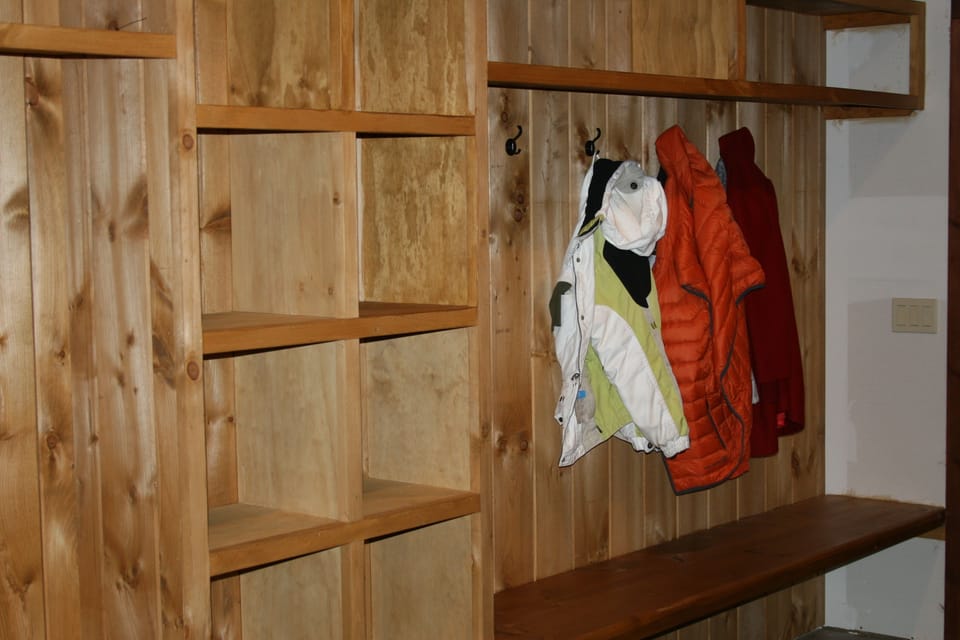 Ski entry has hooks, cubbies, shelves and benches on both sides.