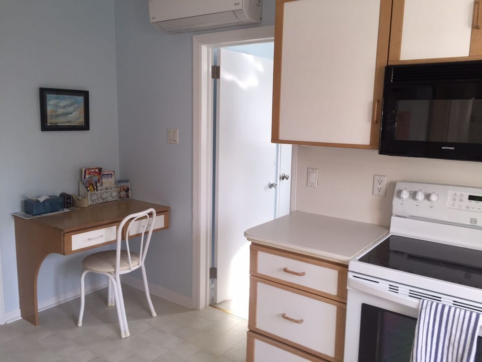 kitchen desk looking onto large laundry room