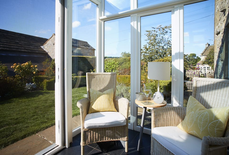 Ground floor: Modern conservatory opens out onto the rose garden